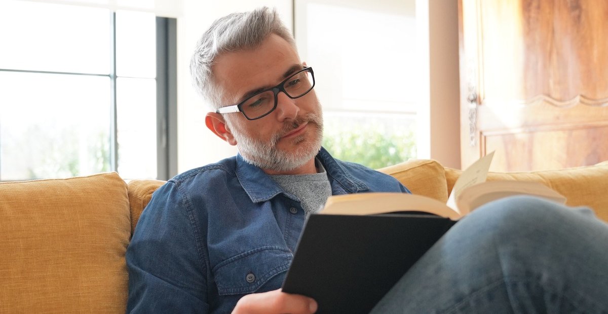 man reading Psalms on a couch looks to find out what selah means