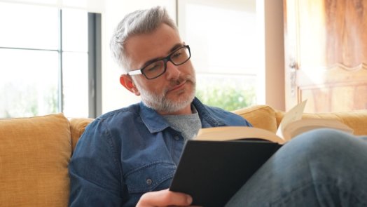 man reading Psalms on a couch looks to find out what selah means
