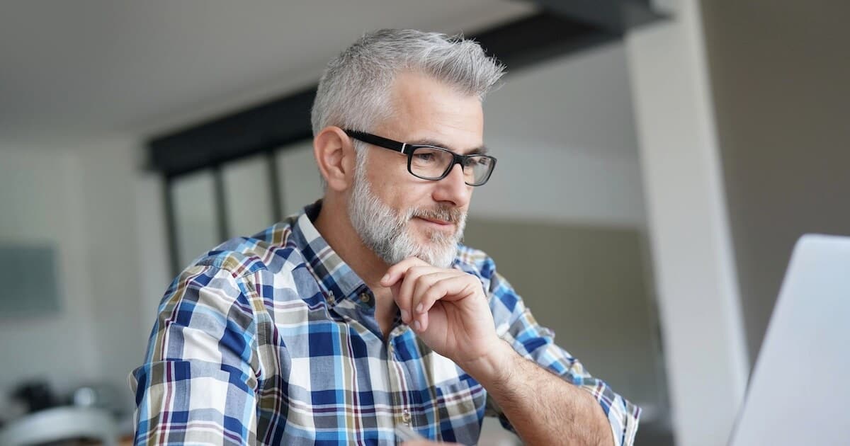 man on computer for post about Bible doctrine