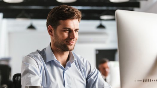 Man on computer for a post about Dr. Carl Sanders