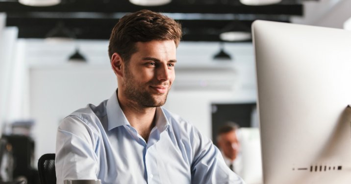 Man on computer for a post about Dr. Carl Sanders