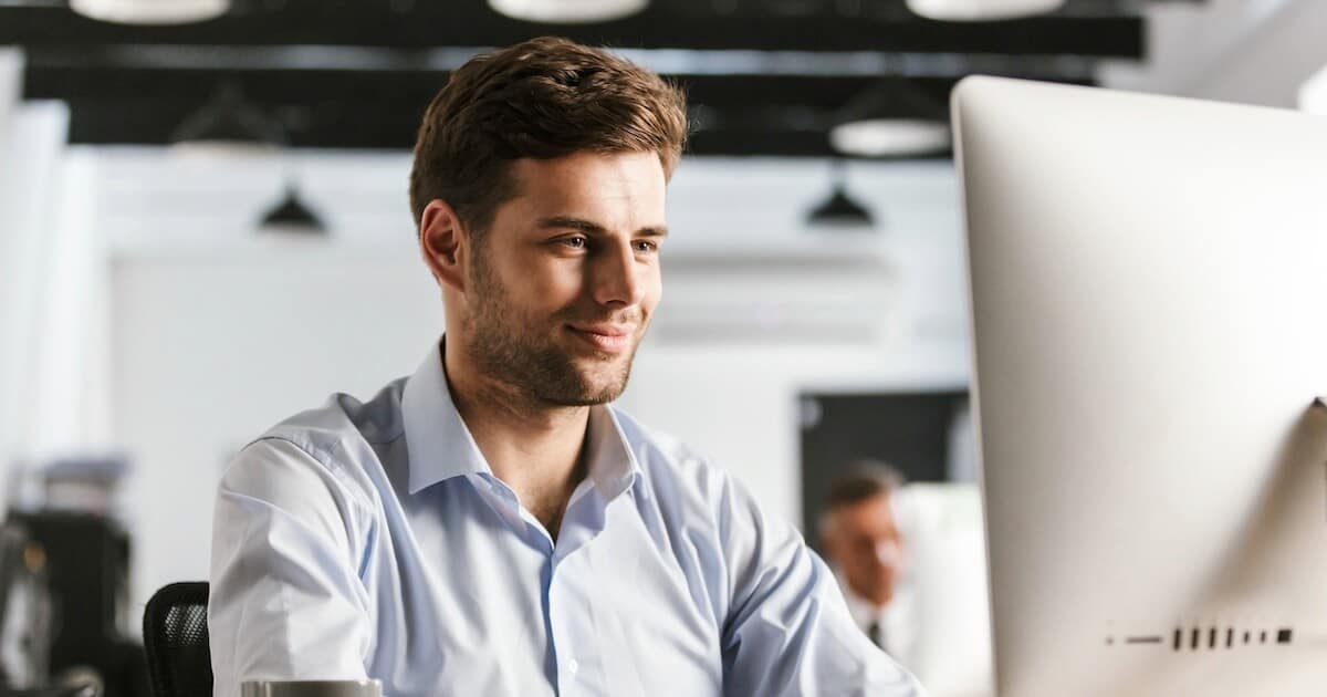 Man on computer for a post about Dr. Carl Sanders