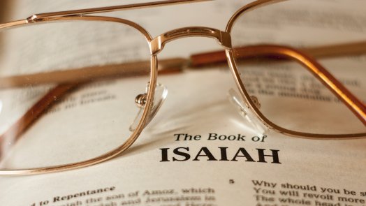 image of glasses on a bible for a post about a commentary on Isaiah
