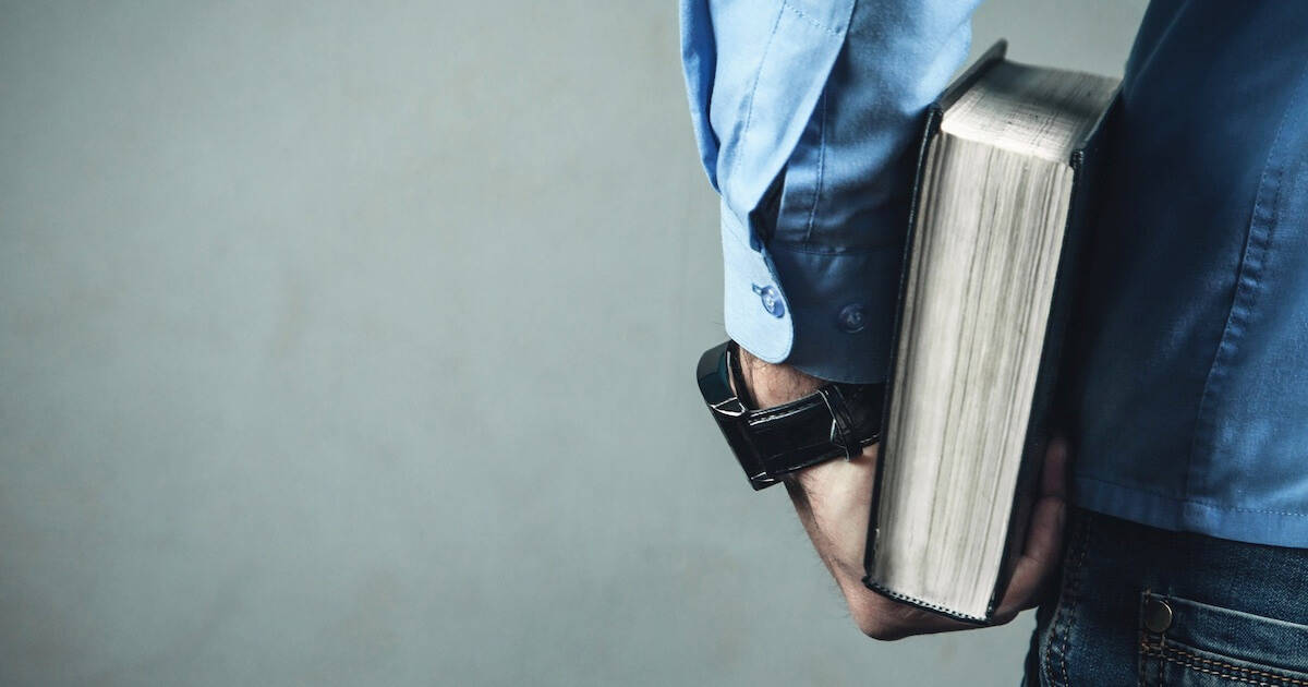 man holding a bible for a post about the best Bible translation