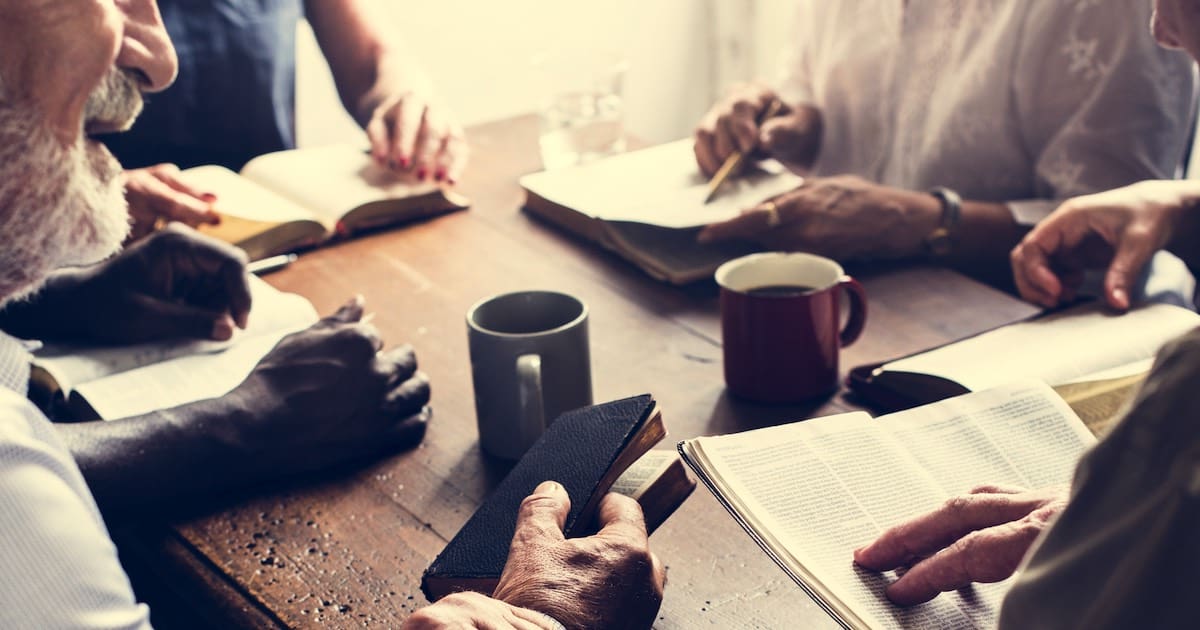 image of church members studying the bible for a post about healthy church members