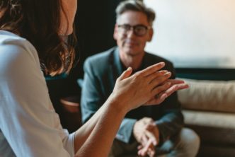 man and woman on coaches talk about a cultural issue