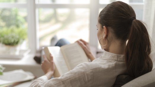 Image of a woman reading for a post about a devotional by D. A. Carson that helps you read the Bible better