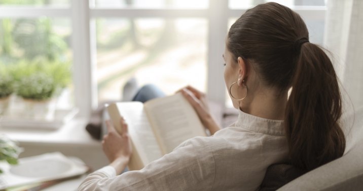 Image of a woman reading for a post about a devotional by D. A. Carson that helps you read the Bible better