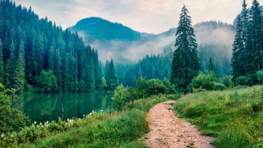 Trail next to a mountain and lake