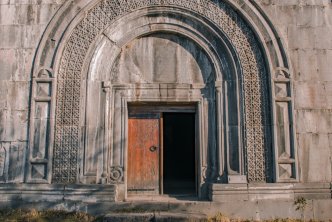 Medieval door on elaborate wall