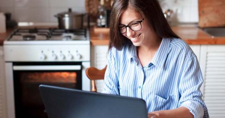 woman at computer for a post about using Canvas in Logos