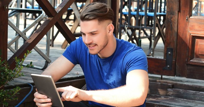 Man reading on ipad for a post about Bible reading