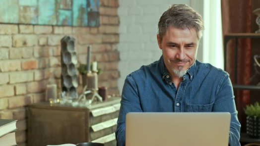 man on computer using logos media search