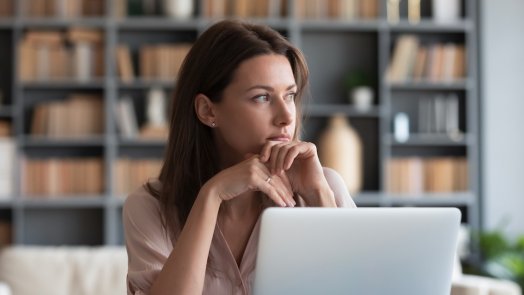 Woman thinking at computer for a post about proverbs