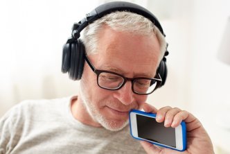 Image of a man listening to a podcast for faithlife Bible podcast post