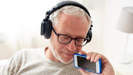 Image of a man listening to a podcast for faithlife Bible podcast post