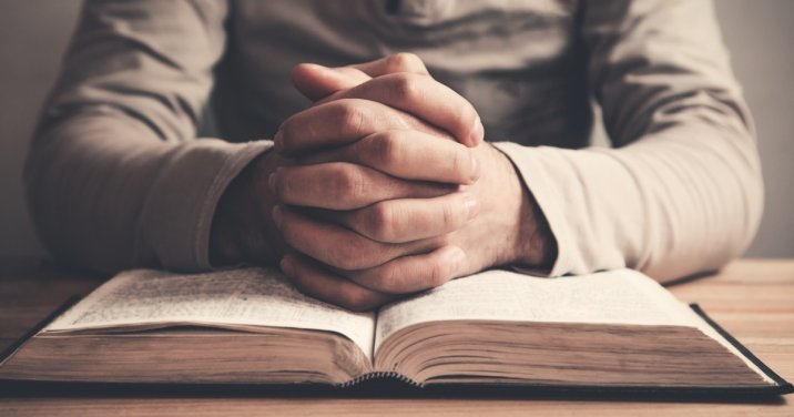 image of man praying over bible for post about old testament prayers