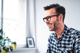 man at desk uses Logos Bible Software on desktop computer