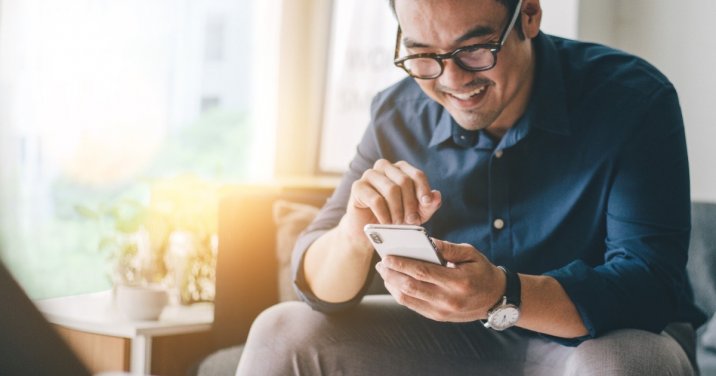 Man on a couch using one of the best Bible apps