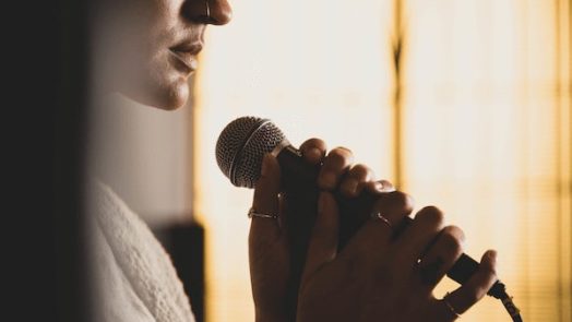 woman singing a worship song about trusting God in hard times