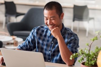 man at desk does an inductive Bible study on laptop