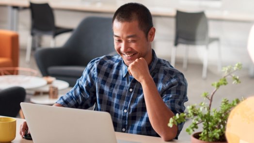 man at desk does an inductive Bible study on laptop