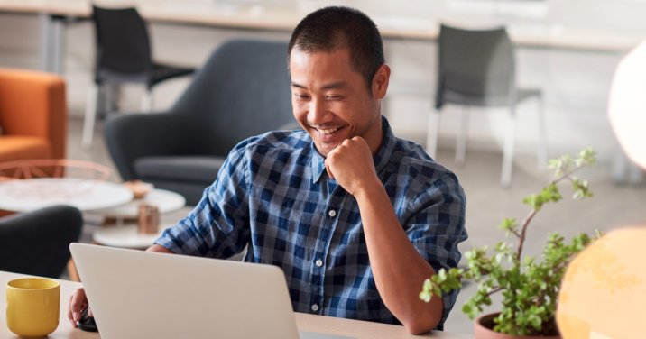 man at desk does an inductive Bible study on laptop