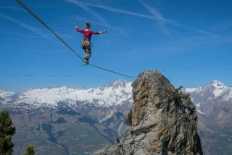 woman showing faith walking on a tightrope