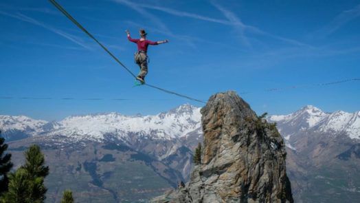 woman showing faith walking on a tightrope