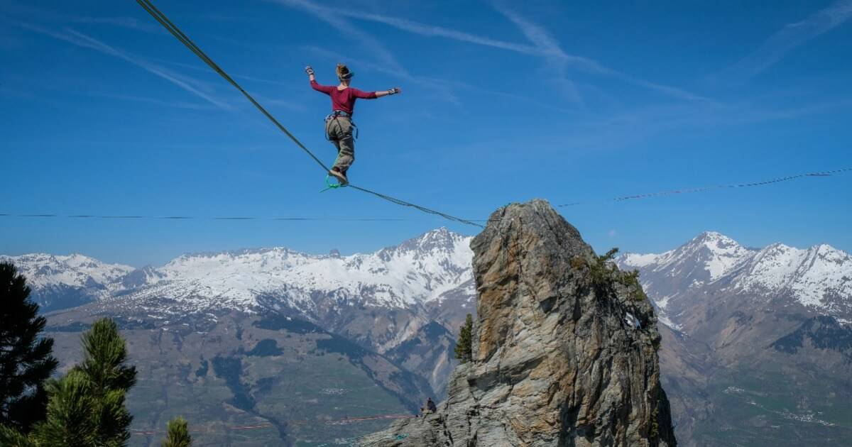 woman showing faith walking on a tightrope