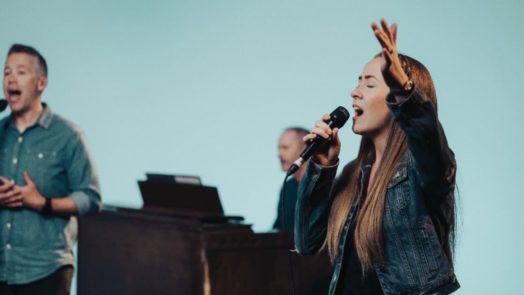 new worship team member singing during church service