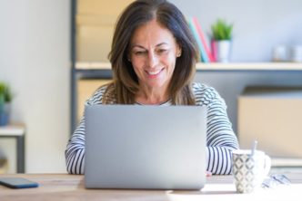 woman at desk looking at Logos 10 Bible app packages