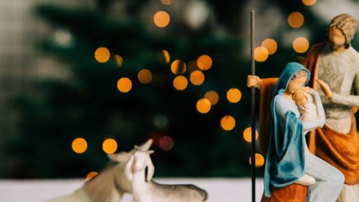 wooden nativity in front of Christmas tree