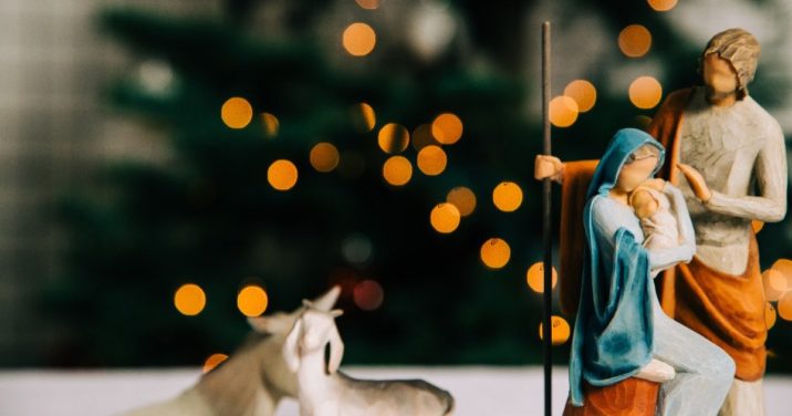 wooden nativity in front of Christmas tree