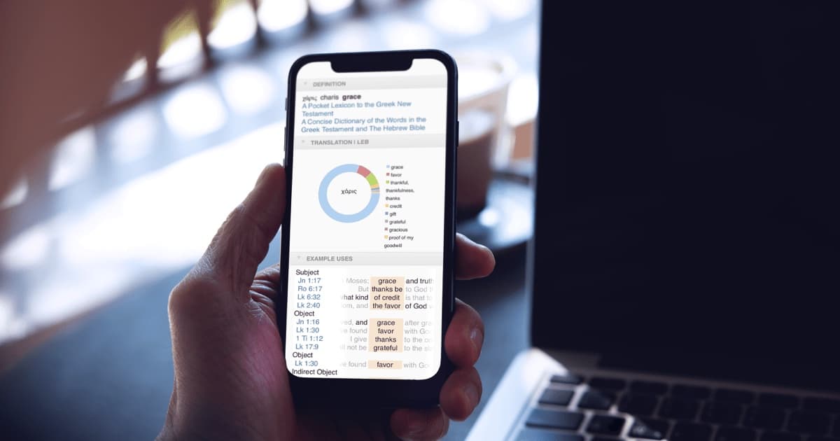 man at desk does a Bible word study on "grace" with the free Logos Bible app