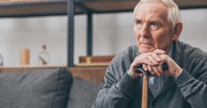 elderly man on couch listening to worship songs about suffering