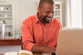 man at desk uses Logos Bible Software on laptop