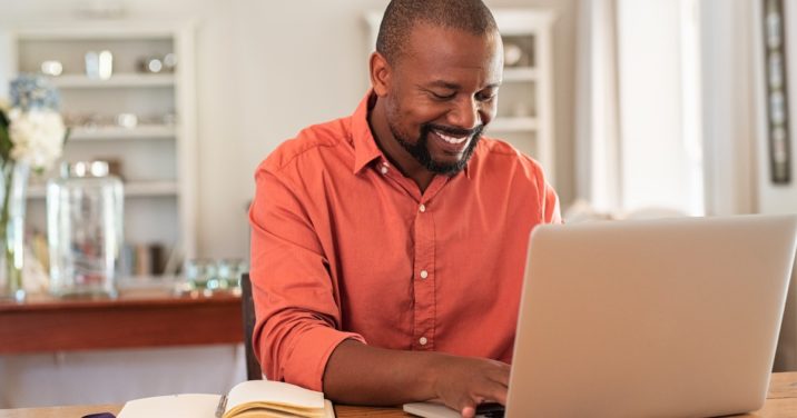 man at desk uses Logos Bible Software on laptop