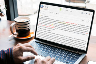 person at desk with laptop using Logos visual filters to study the Bible