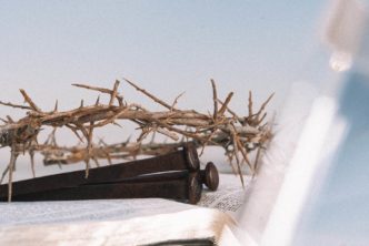 crown of thorns and nails lying on open Bible to illustrate meanings of the Greek word logos