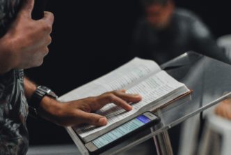 pastor at pulpit preaching to congregation