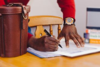 man at desks marks schedule to make time to study biblical languages