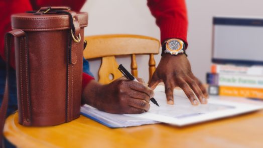 man at desks marks schedule to make time to study biblical languages