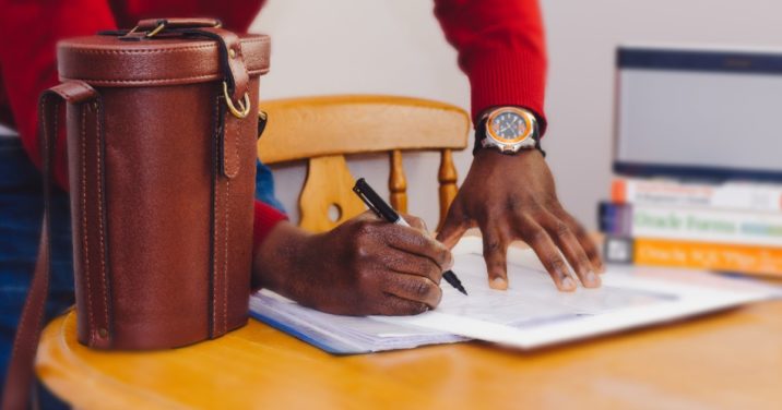 man at desks marks schedule to make time to study biblical languages