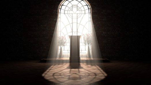 sun streams through stained glass window with cross inlay
