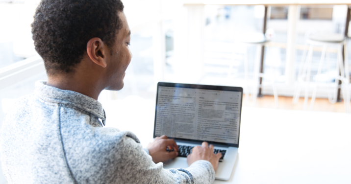 man at desk studies church history on laptop using Logos