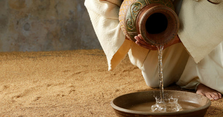 Jesus pouring water from a jar before the feet washing