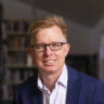 Mike Bird Sitting in Library.jpg e x