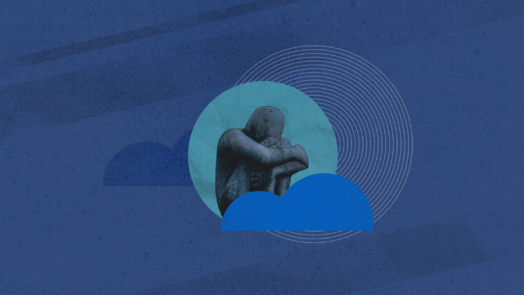 sculpture of grieving man against a blue background